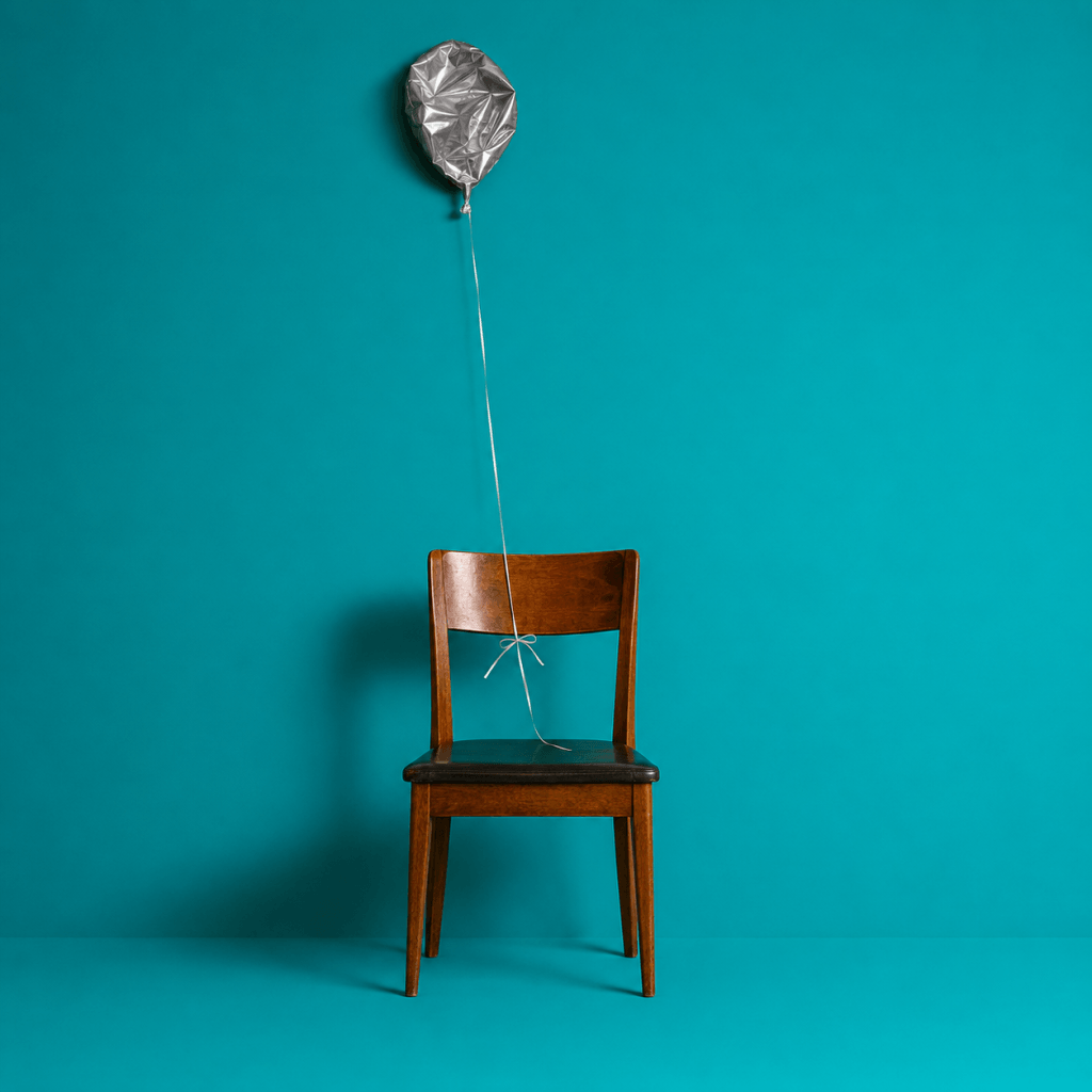Goal tracking systems: why most goals die in silence - single deflated balloon on a string tied to an empty chair after a party