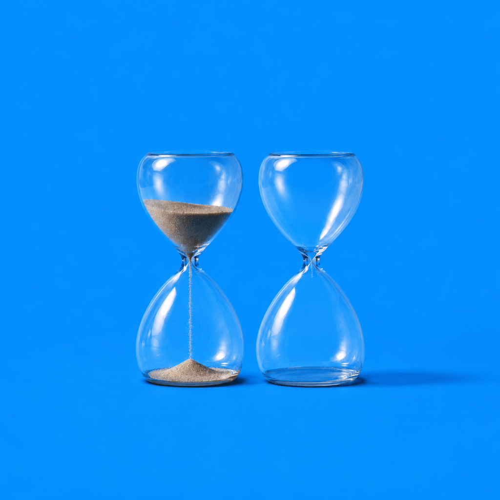 Annual Review Template: Three-Question Annual Wrap-up - single hourglass with the last grains of sand falling as a new hourglass begins beside it