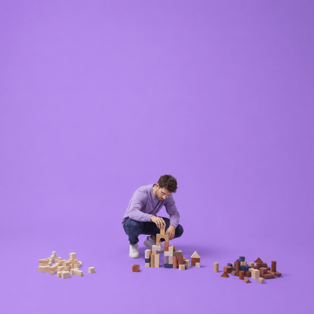 Habit Architecture Blueprint Builder - person assembling small wooden blocks from different sets into one structure