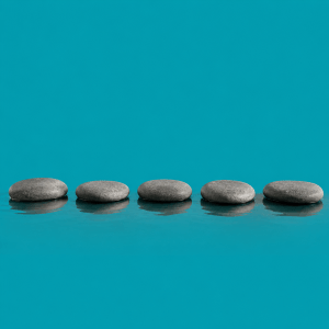 How to stay motivated long term: a 5-practice cadence - single row of five smooth stepping stones crossing a calm stream