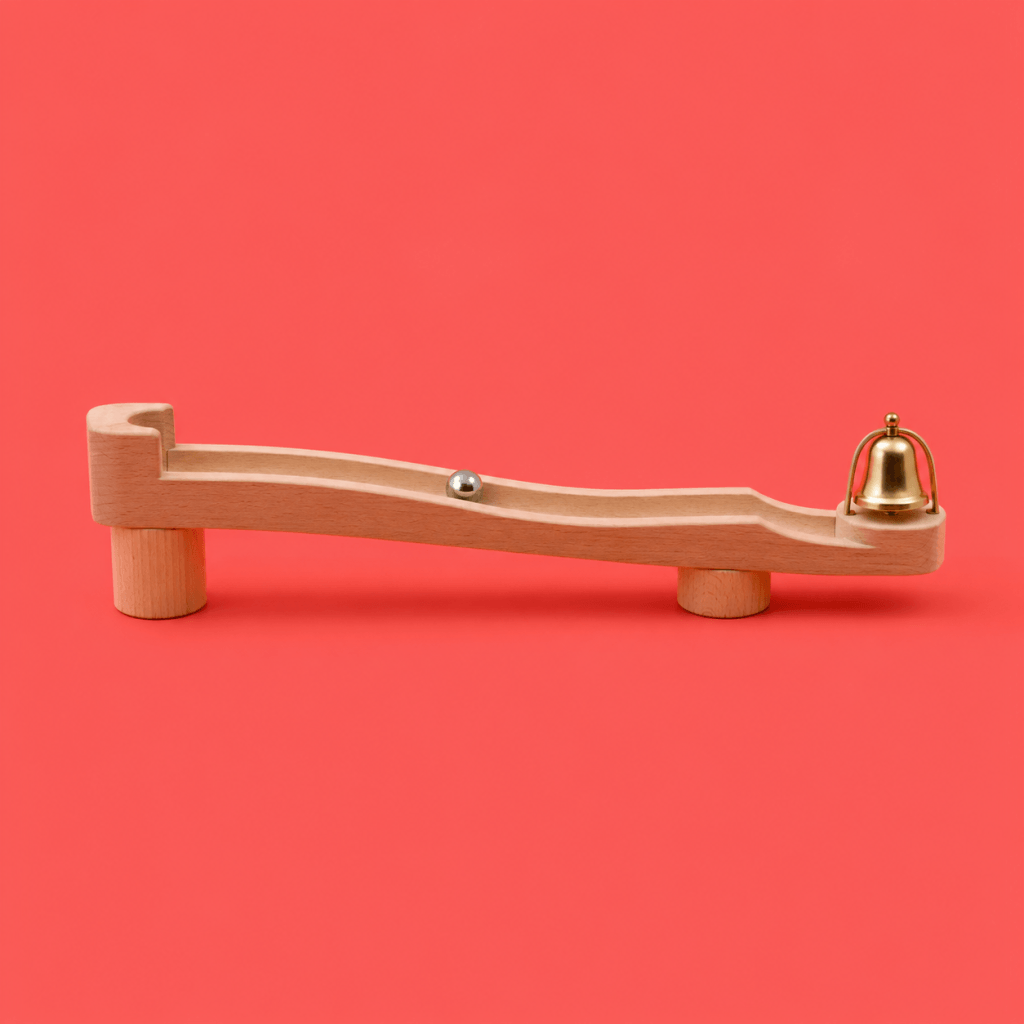 Cue Routine Reward: the Habit Loop Explained (2026) - single marble run track with a marble mid-roll toward a small bell