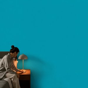 Close your day and your week in the Life Goals App: a person setting a phone to charge on a nightstand in dim evening light