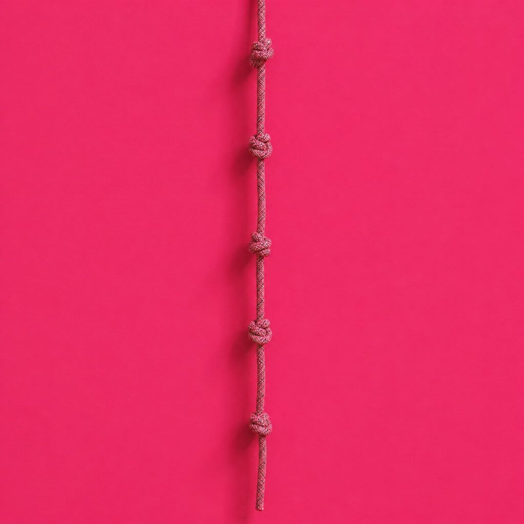 Plan your annual goals from your Summit Goals with the Life Goals App: a knotted climbing rope hanging against a wall with evenly spaced knots
